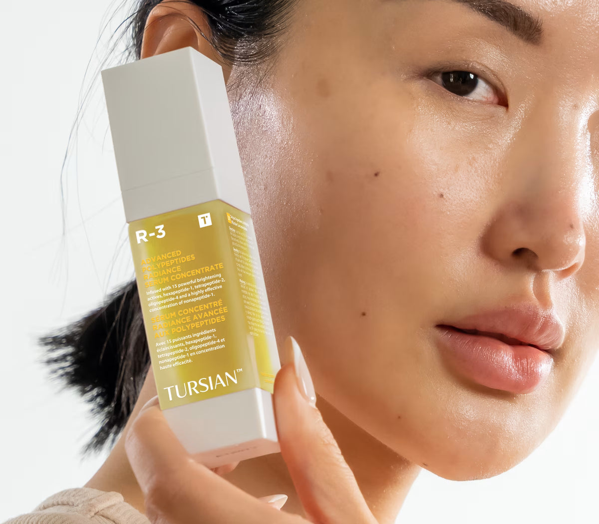 Model holding R-3 Advanced Polypeptides Radiance Serum Concentrate